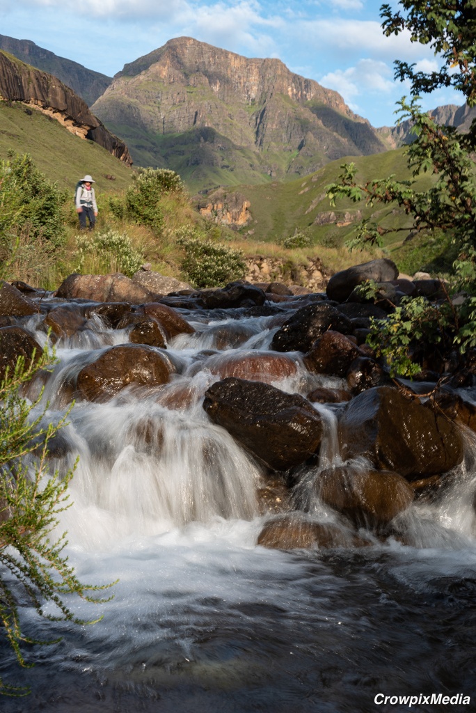 alt="landscape photography 50mm mountain river water stream rock hiker"